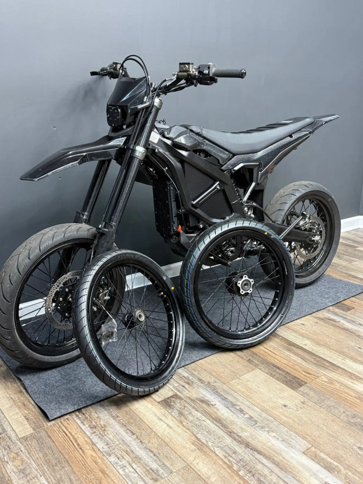 EX Racing performance e-motos with supermoto wheels in the shop